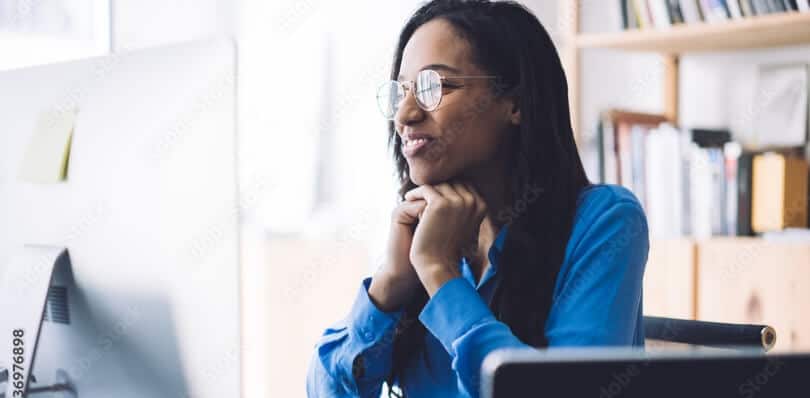 Woman looks at her external monitor