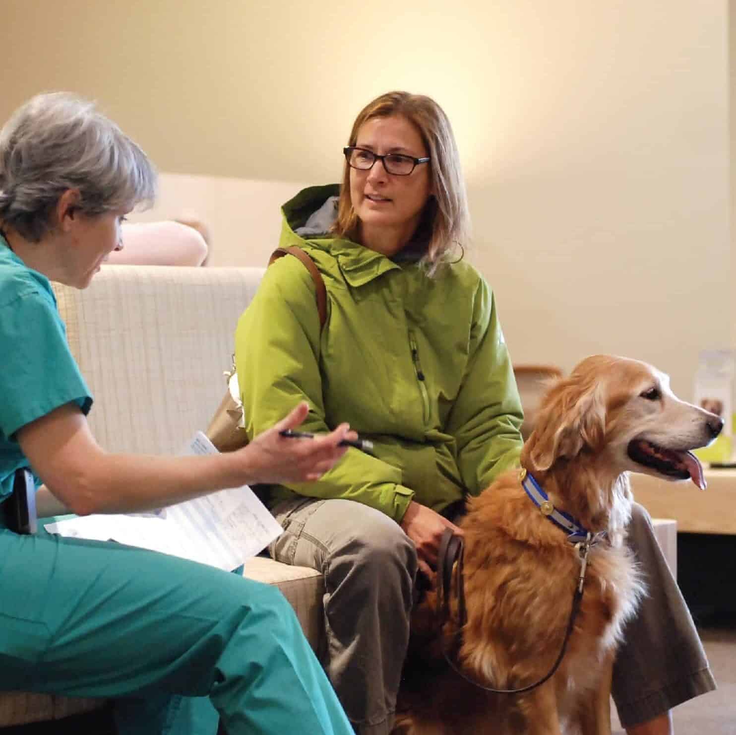 Veterinarian speaking with a patient and owner